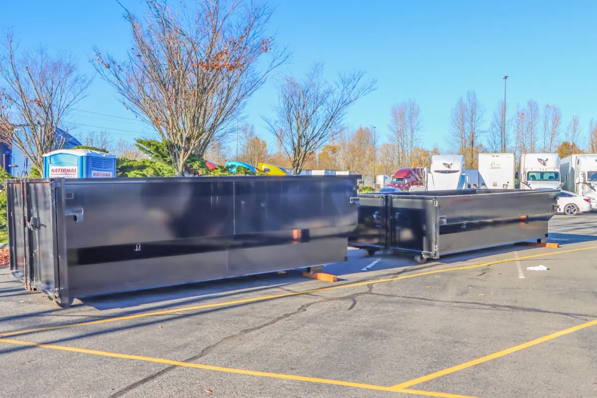 Professional dumpster rental service with roll-off container on residential driveway in Grandview